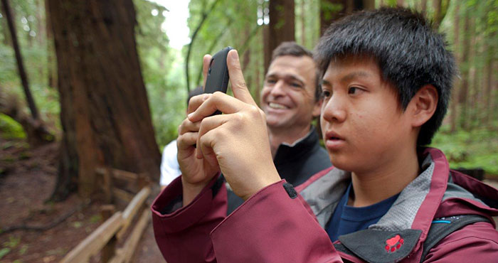 Young students (like the one above with Sam Hodder, League President and CEO) joined the League and other organizations at last spring's BioBlitz to inventory plant and animal species in Muir Woods National Monument. Your gifts support such League projects to introduce new generations to the wonder of the redwoods, improving their health and well-being as they learn about the forest. Photo by Tonatiuh Trejo-Cantwell