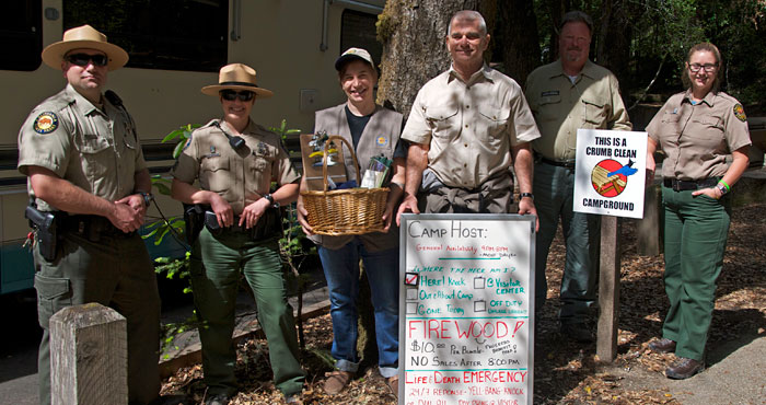 Your gifts helped build a new location for new camp host Liz Elliott (third from left) at Portola Redwoods State Park. Elliott provides information to campers and helps them in emergencies. Your contributions support projects like this to improve your exp