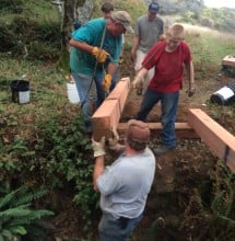 Joseph Haas (in red shirt) and team members build a bridge in Sinkyone Wilderness State Park.
