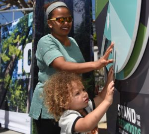 Selam Jaser and her son Zachary learn about the plants and animals of the redwood forests in our new interactive booth. Photo by Paolo Vescia