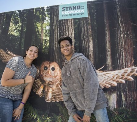 Festival-goers Macari Dawson and Cameron Dyal pose with a northern spotted owl at the League’s booth. Photo by Paolo Vescia