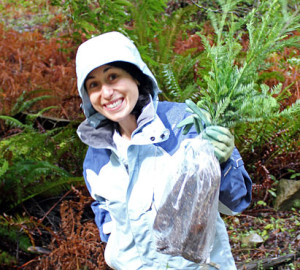 Sharon Rabichow, Director of Planned Giving, helps plant seedlings at an event honoring a League member.