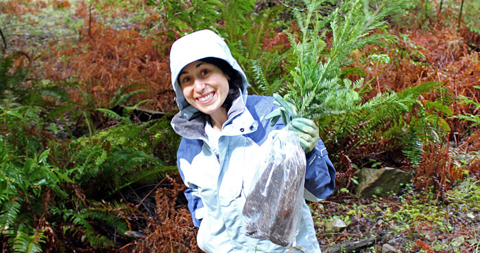 Sharon Rabichow, Planned Giving Officer, helps plant seedlings at an event honoring a League member.