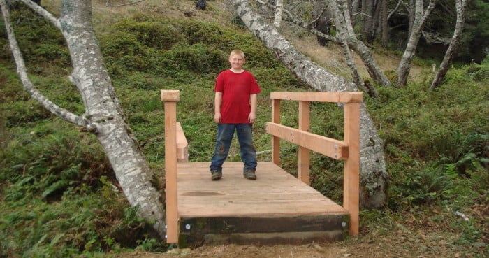 Joseph Haas proudly tries out one of the new bridges. Photo courtesy of the Haas family