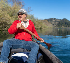 Josh Norris canoeing in a red jacket on the Klamath river