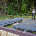 Brett Silver, California State Parks Acting Sector Superintendent, stands on design samples for the elevated walkway which will provide visitor access to the Grove of Titans while protecting the sensitive habitat. Photo by Max Forster, @maxforsterphotography.