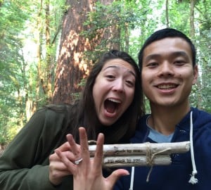 Elizabeth Su and Andrew Lee celebrate their engagement in Redwood National Park with sticks that say “Stick by me … I’ll stick by you.”  Elizabeth’s family has a long history of dedication to the redwood forest.