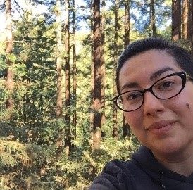 Janell Banday admires the redwoods at Joaquin Miller Park. This park offers multiple redwood groves, many trails, and a distant view of the Bay Bridge.