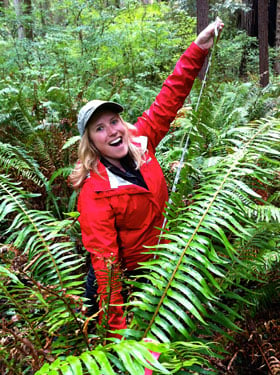 Emily Burns can barely measure the length of this Jedediah Smith Redwoods State Park sword fern because it is so big.