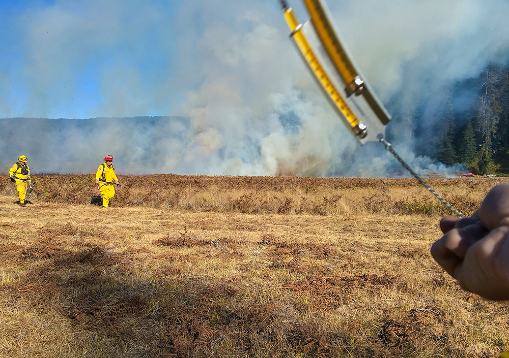 A sling psychrometer is used to measure temperature and relative humidity. Every hour, weather measurements are recorded and announced over the radio, allowing crews to anticipate fire behavior.
