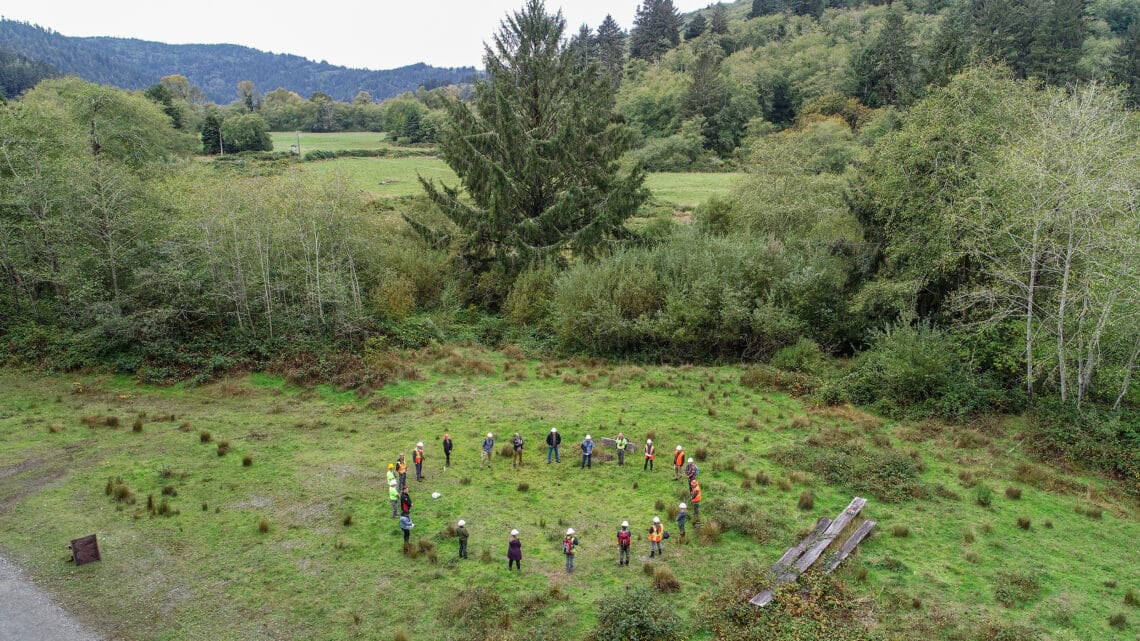 A group of people in a circle in a field