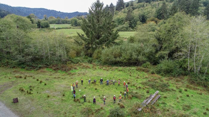 A group of people in a circle in a field