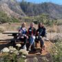 From left: Karen Wickers, Karen Gilhuly and Mary Hufty sit in the native plant garden that they and their fellow Woodside-Atherton Garden Club members, and members of other Garden Club chapters, planted next to the new Rancho del Oso Welcome Center. Photo by Jennifer Charney, Save the Redwoods League