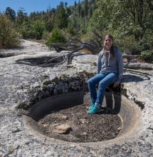 Case Mountain features granite basins, long believed to have been created by Native Americans. Jessica Neff, the League’s Land Project and Stewardship Manager, tries one on for size.