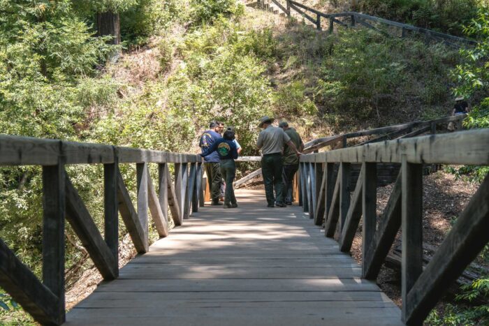 Park rangers on a bridge