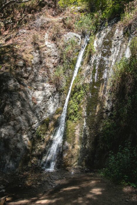 waterfall streaming along mossy rock