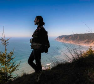Estelle Clifton, registered professional forester and botanist with North Coast Resource Management (NCRM), looks out over the Pacific from Lost Coast Redwoods. Photo by Max Whittaker, courtesy of Save the Redwoods League.