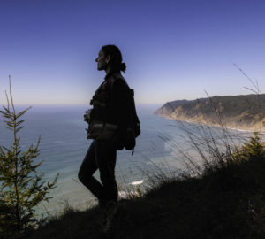 Estelle Clifton, registered professional forester and botanist with North Coast Resource Management (NCRM), looks out over the Pacific from Lost Coast Redwoods. Photo by Max Whittaker, courtesy of Save the Redwoods League.