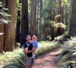 A Jewish man and his daughter in a redwoods forest