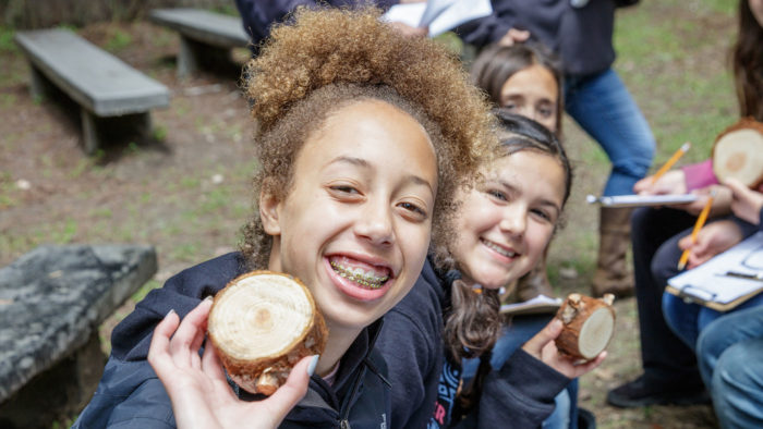 Students holding tree cookies