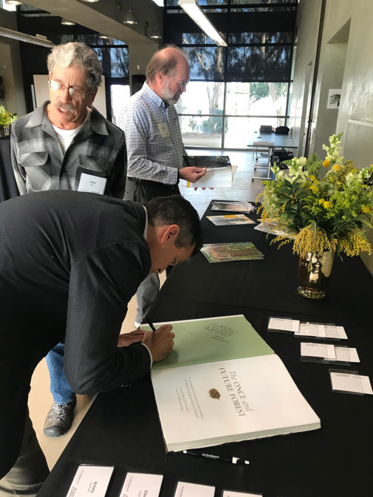 League's president signing book