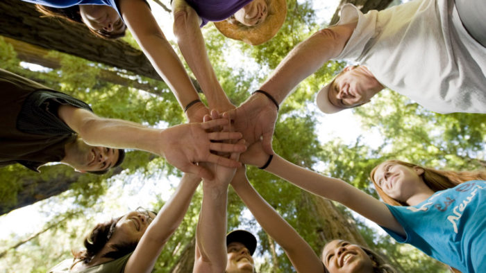  Depositphotos Many hands getting together in the center of a circle