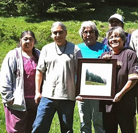 Priscilla Hunter (holding photo, right) celebrates the League's donation of the Four Corners property to the organization she co-founded, the InterTribal Sinkyone Wilderness Council.
