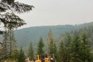 Heavy equipment is used to remove roads and recountour the landscape back to its previous topography.