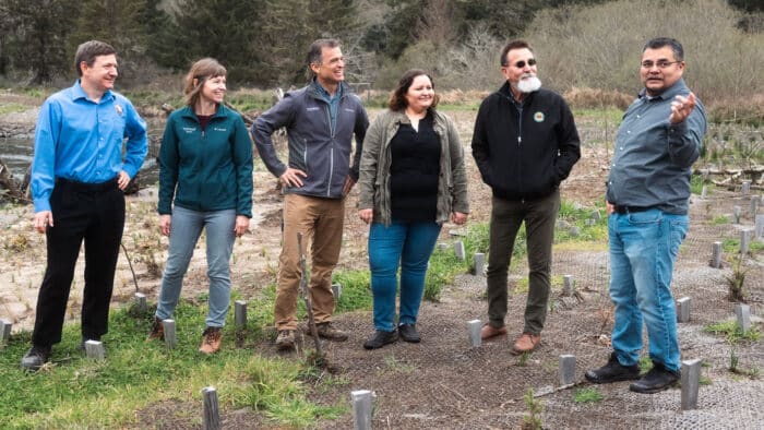six people standing outside on the floodplain of Prairie Creek