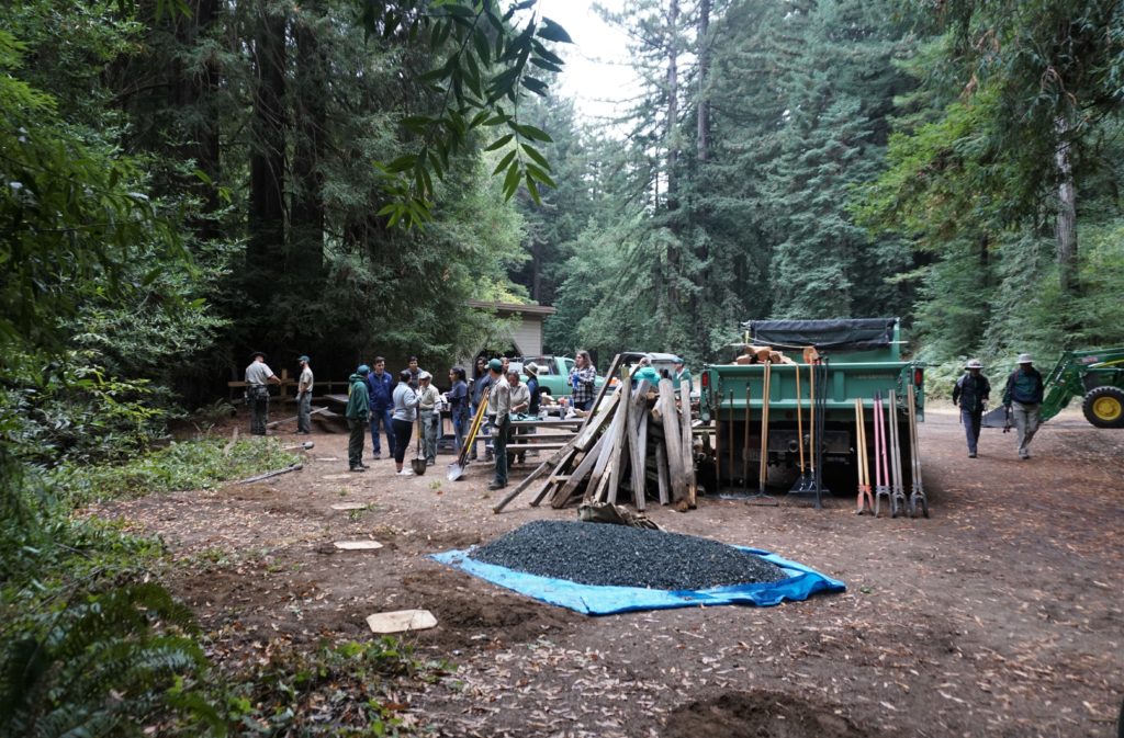 The worksite. Each square of wood in the ground covers a hole that will get filled by a fence post and gravel to stabilize the post.