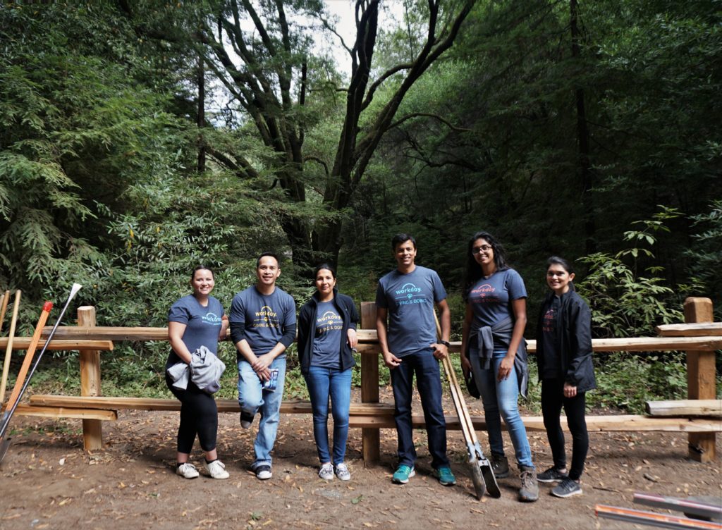 Volunteers from Workday standing in front of a portion of the newly-built fence.